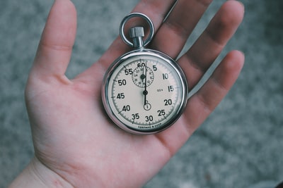 Holding a white and silver pocket watch
